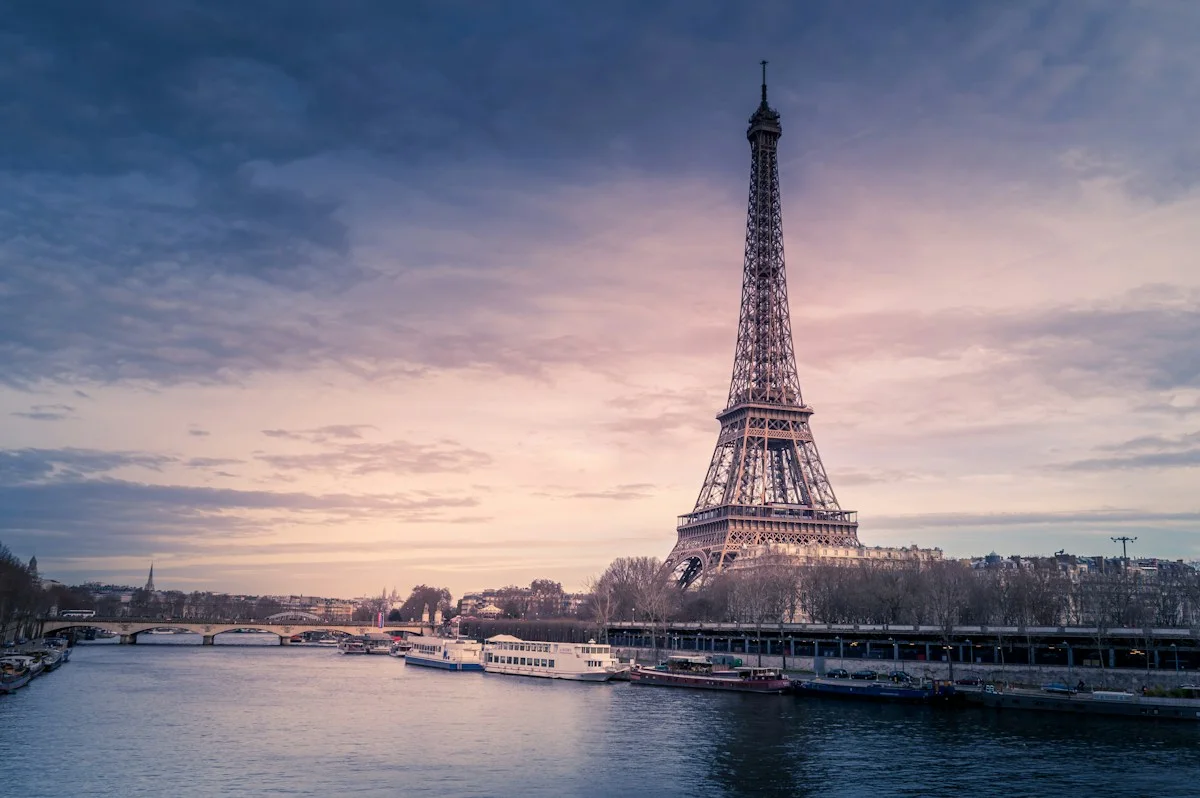 Eiffel Tower beside the Seine beneath an evening sky