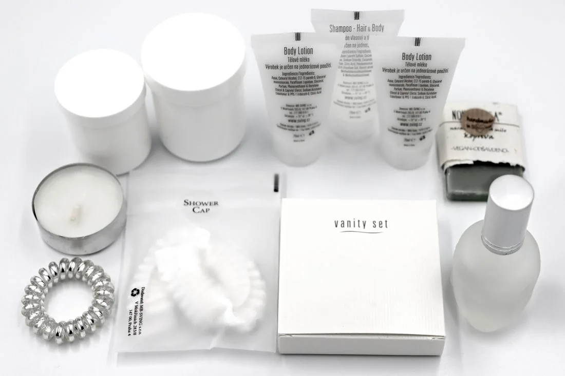 Small toiletries and hotel amenities arranged on a surface