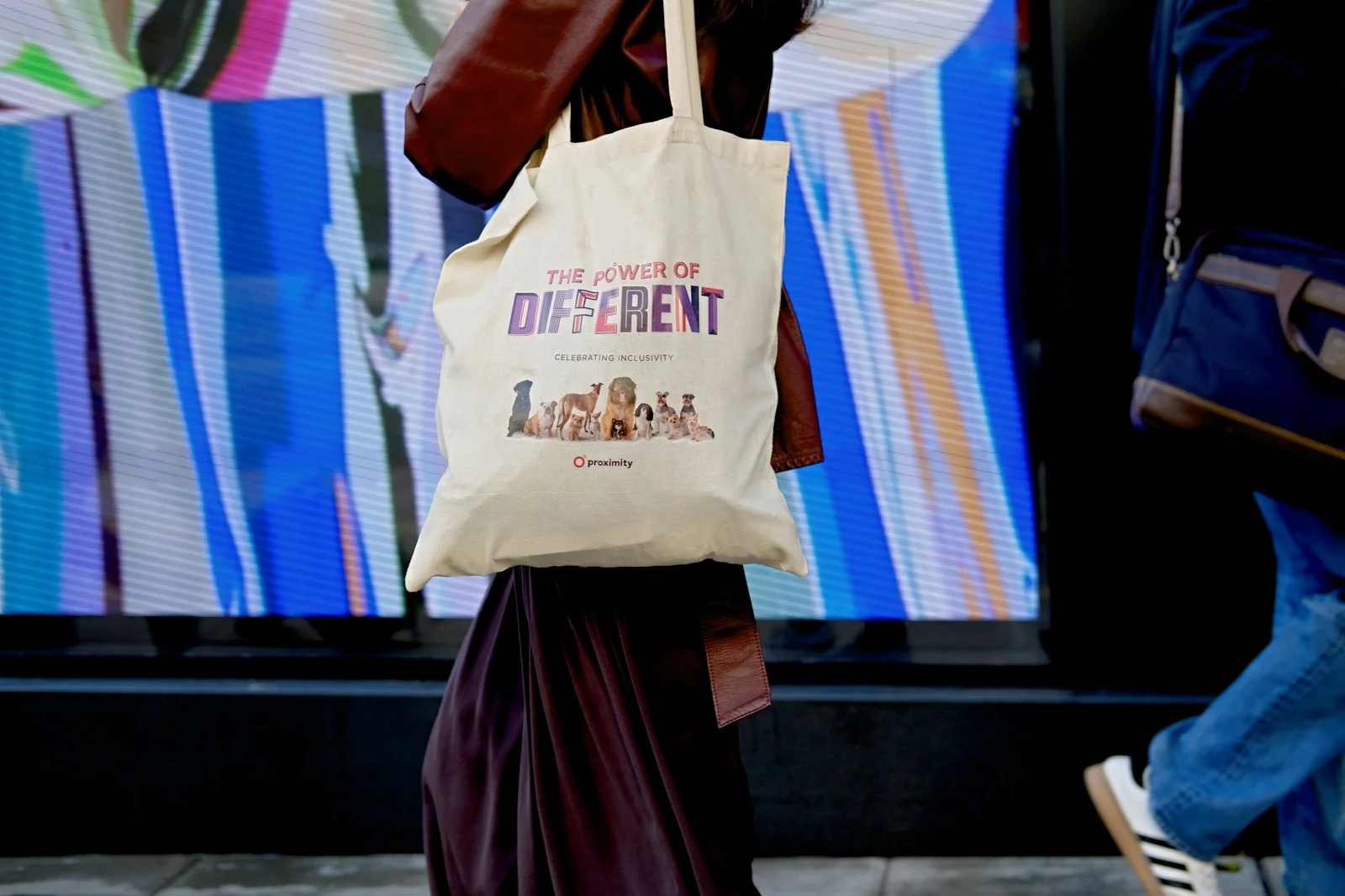 A person holding a white canvas tote bag
