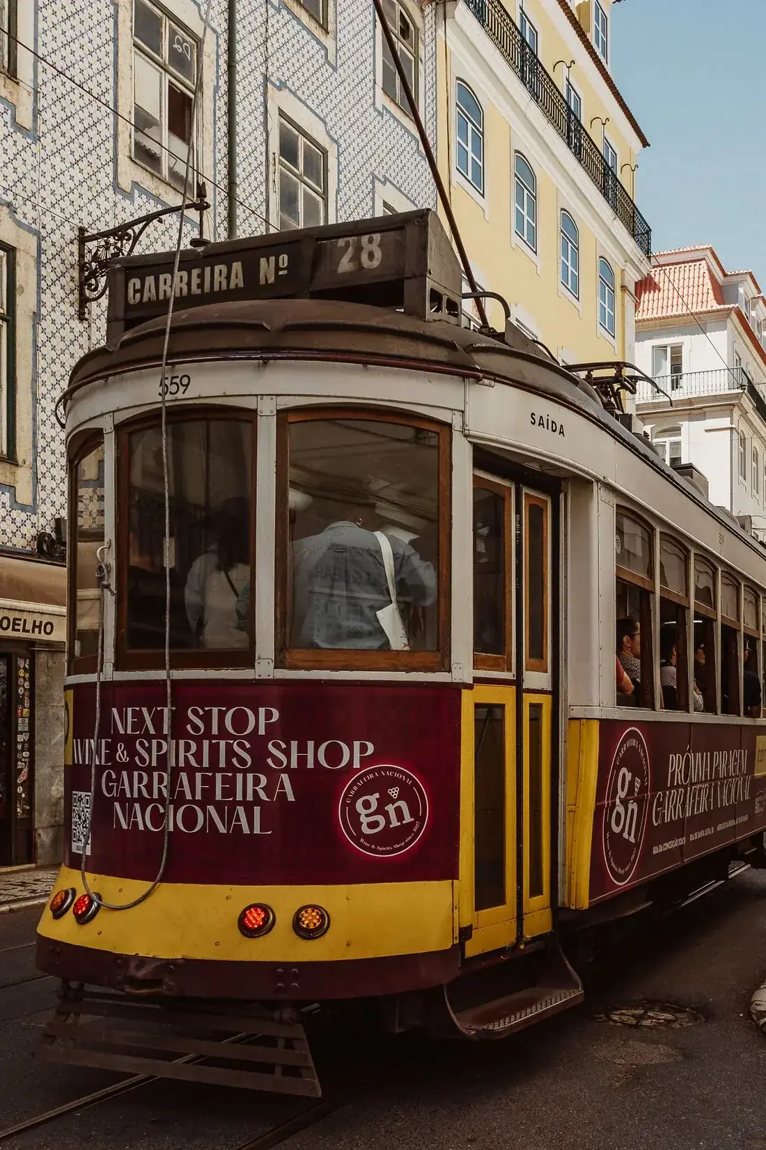 A close view of a brown and cream tram on a city street