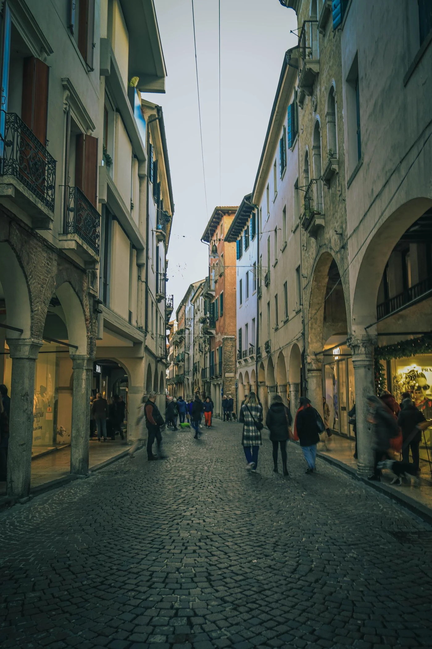 A historic street with pedestrians in Padua.
