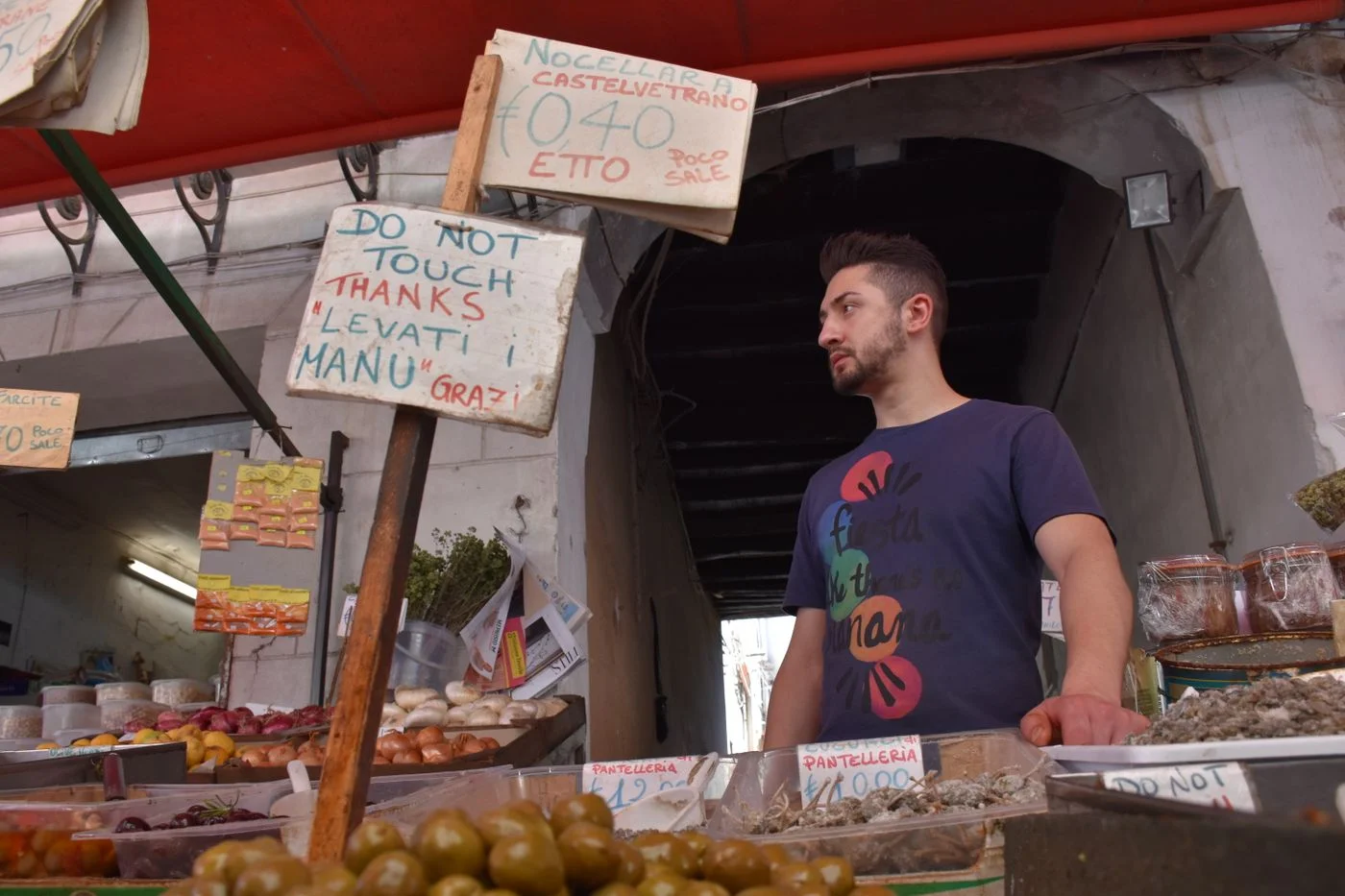 A food stall and vendor in a Palermo market.