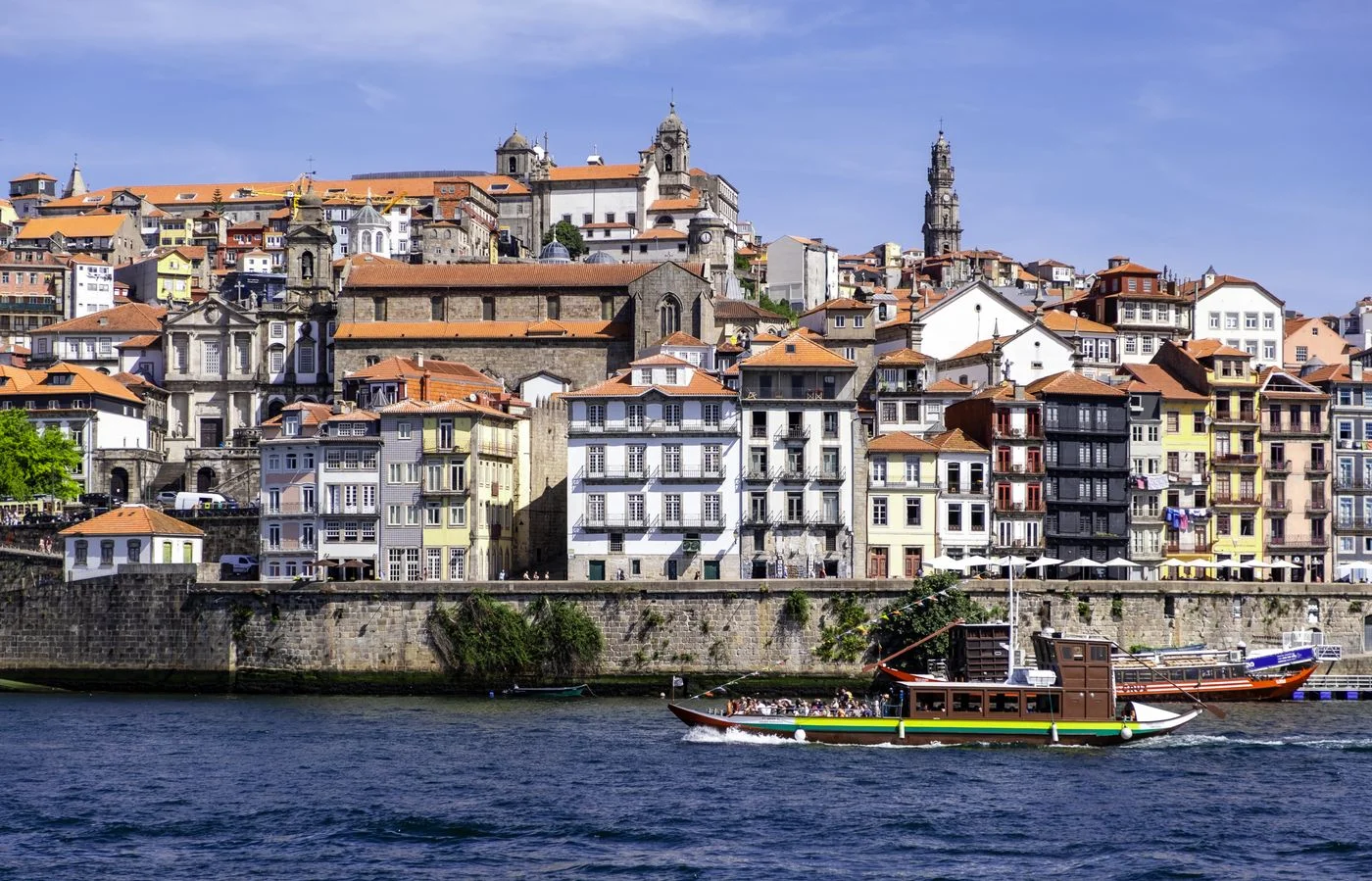 Colorful buildings and riverboats beside the Douro in Porto's Ribeira district.