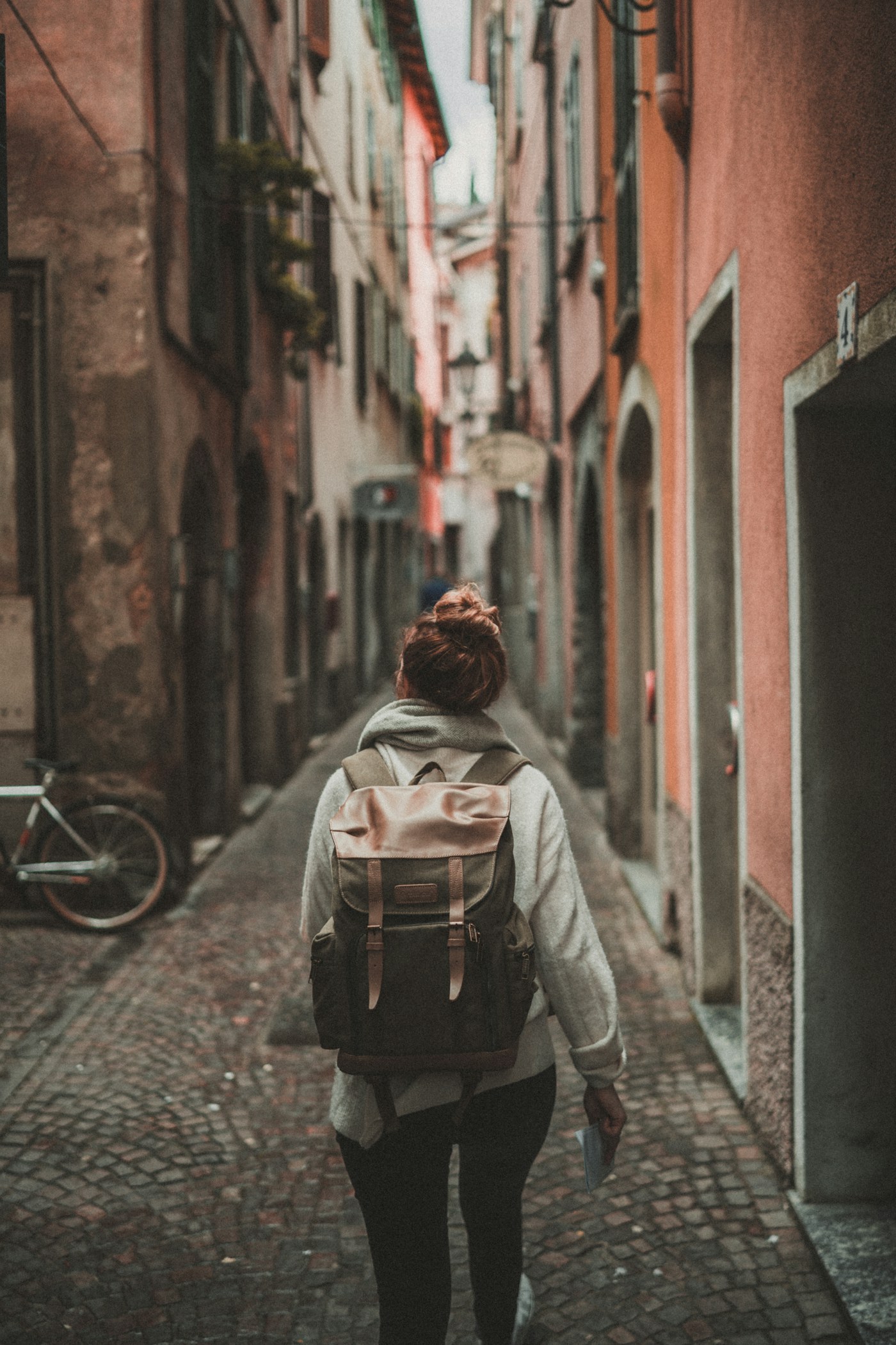 Traveller wearing a backpack in a narrow city street